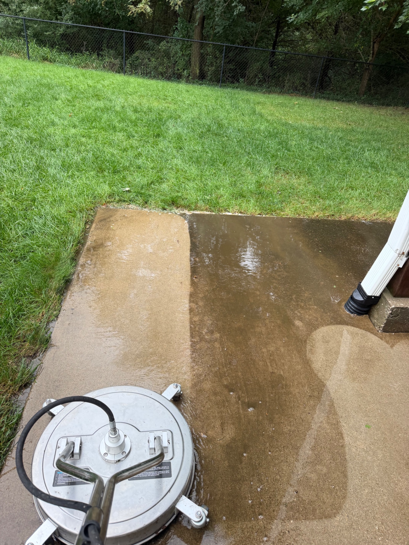 Spotless Wash surface cleaner washing a concrete patio