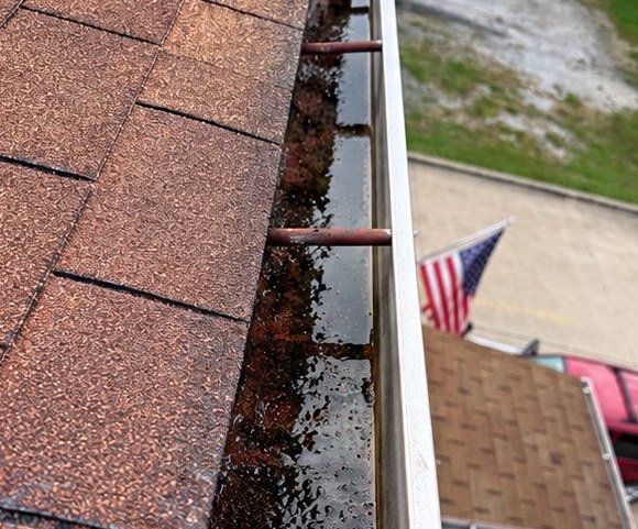 Gutter cleaning — before cleaning or restoration