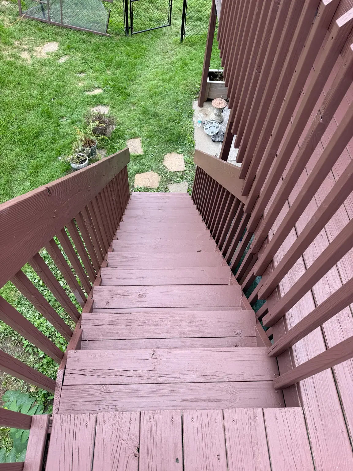 Freshly stained and painted deck stairs by Spotless Wash