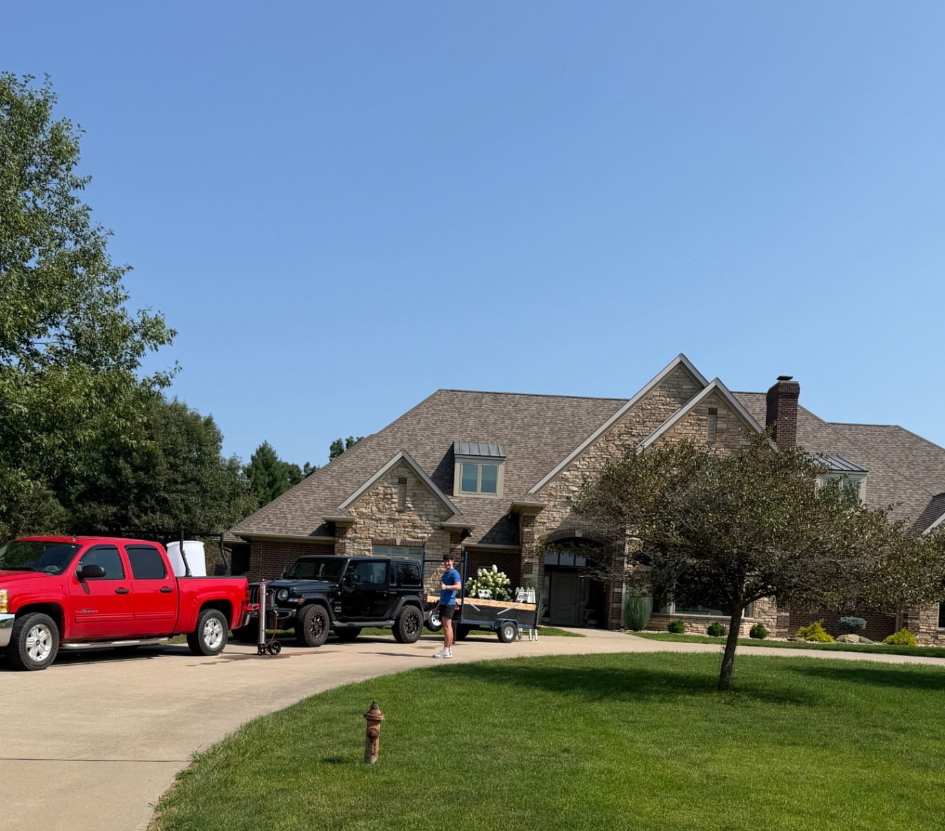 Spotless Wash team and equipment at a residential window-cleaning project